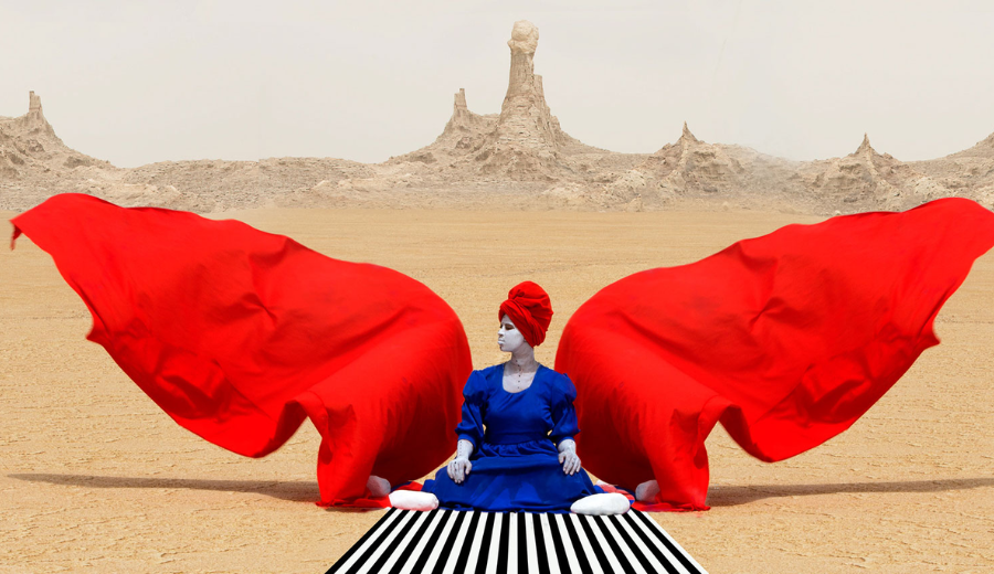 Surreal image of a woman with red and blue attire in a desert, representing Toronto spring festivals and vibrant art events during spring 2025.