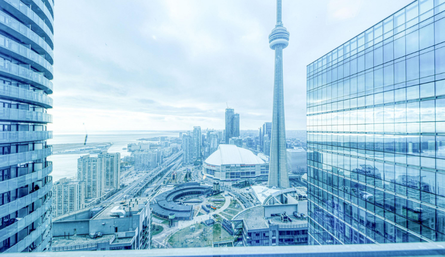 Skyline view of downtown for Canada Day in Toronto 2025 featuring the CN Tower, Rogers Centre, and modern buildings near the waterfront.