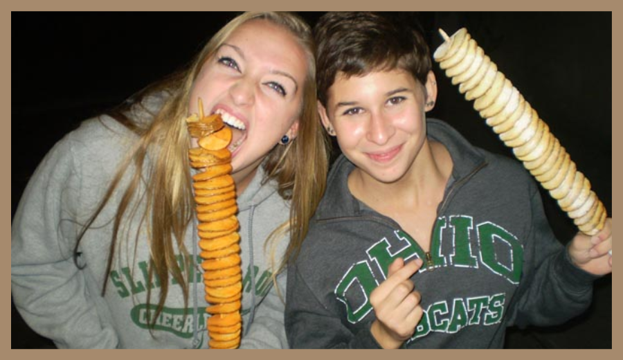 Festivalgoers enjoying Tornado Fries at Toronto Food Truck Festival