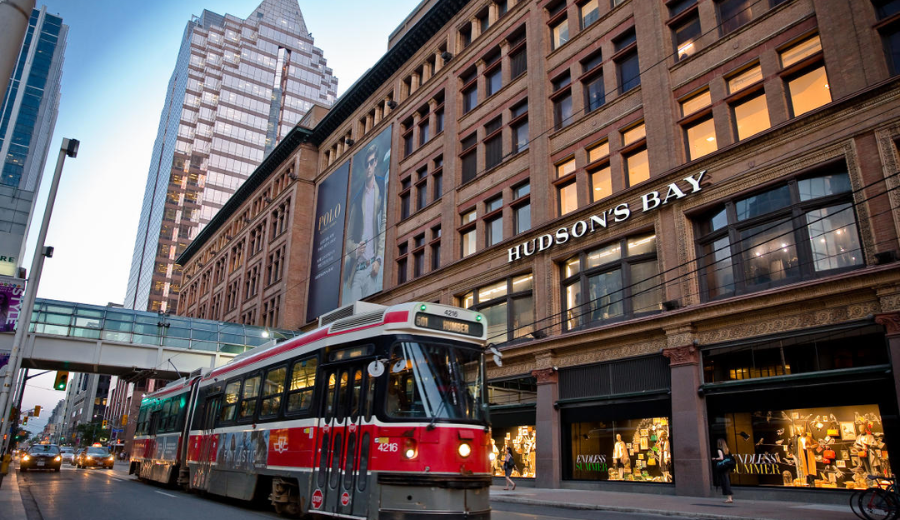 Streetcar passing by Hudson’s Bay department store near RivetStays Toronto downtown location