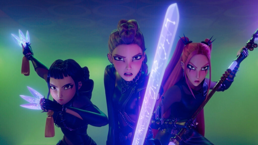 Three female characters from KPop Demon Hunters in battle stance, holding glowing weapons with determined expressions in a vibrant animated scene.