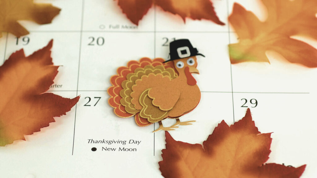 A calendar that has a leaves and thanksgiving time
