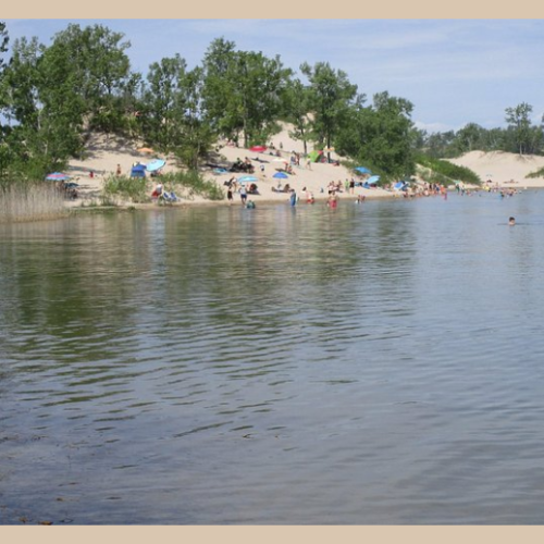 Dunes Beach offers a unique natural backdrop with rare sand dune formations and calm waters, making it a standout feature of this nautical hideaway near Toronto.