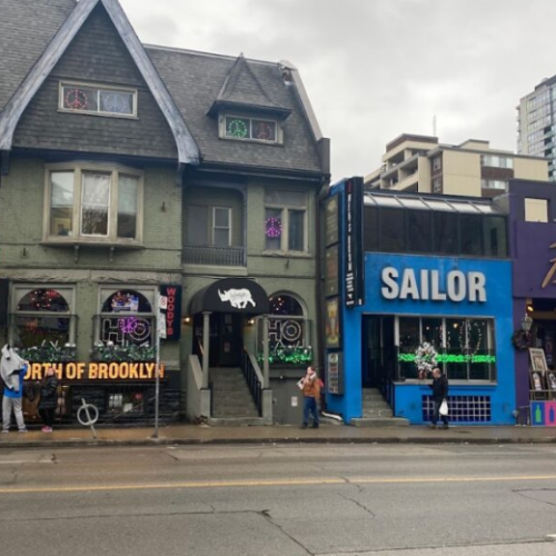 A snapshot of Toronto’s iconic Church-Wellesley Village, home to some of the city’s most beloved queer-owned Toronto spots like Woody’s, Sailor, and Flash. This vibrant strip is the heart of the LGBTQ2S+ community—where nightlife, activism, and celebration meet year-round, especially during Pride.
